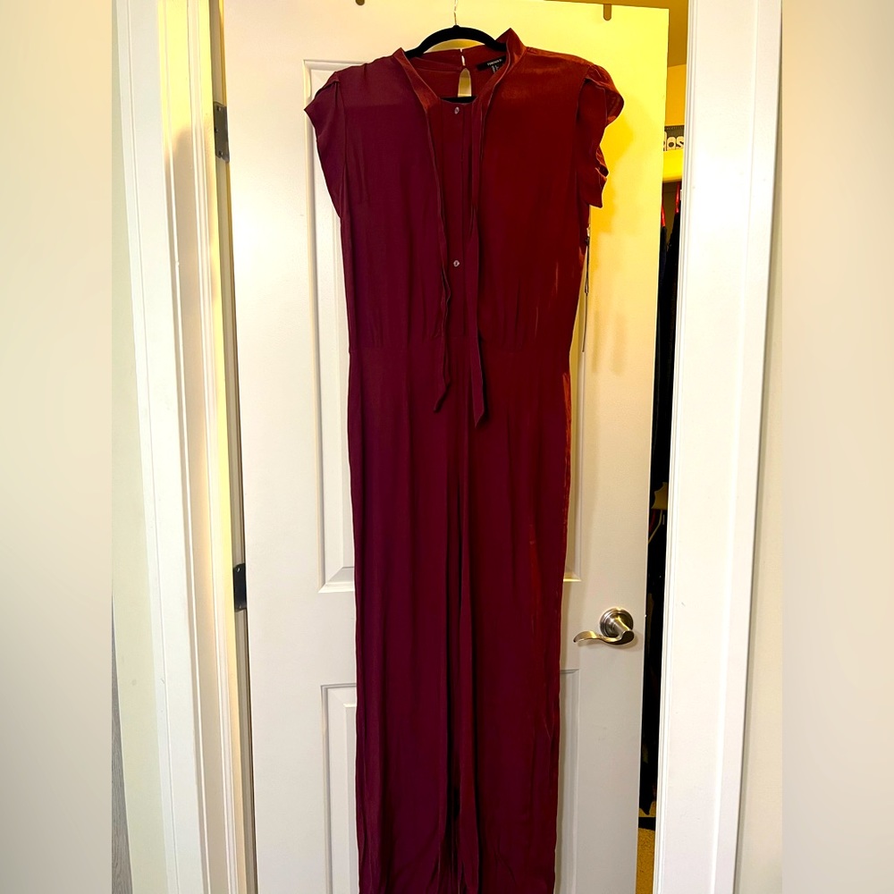 Burgandy Forever 21 Jumpsuit. Features Peekhole back and tie at neck. NWT